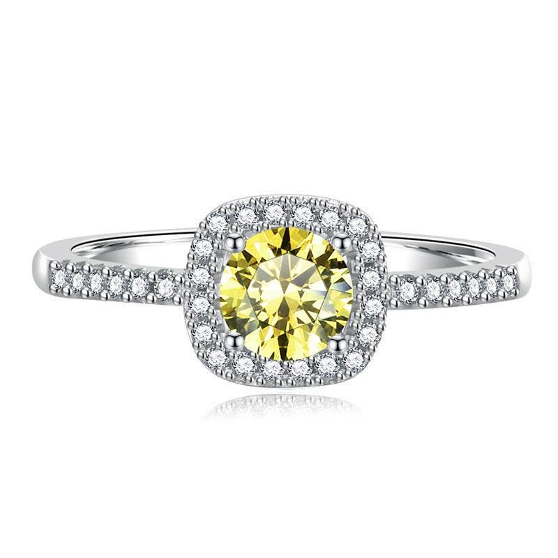 Madison sterling silver halo ring with a Golden Yellow moissanite center stone and pavé-set band on a white background.