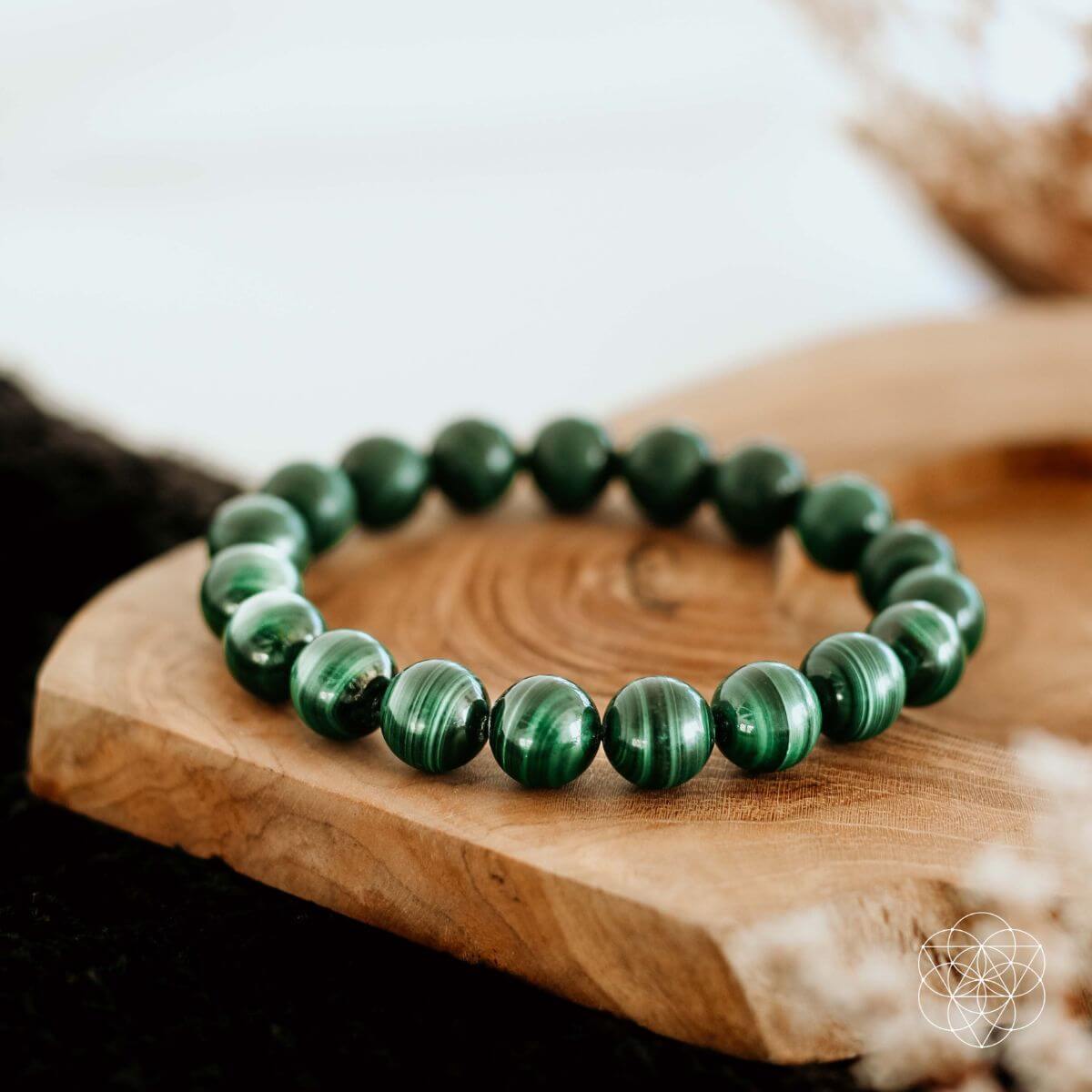 Mazzy natural malachite bracelet displayed on a wooden surface