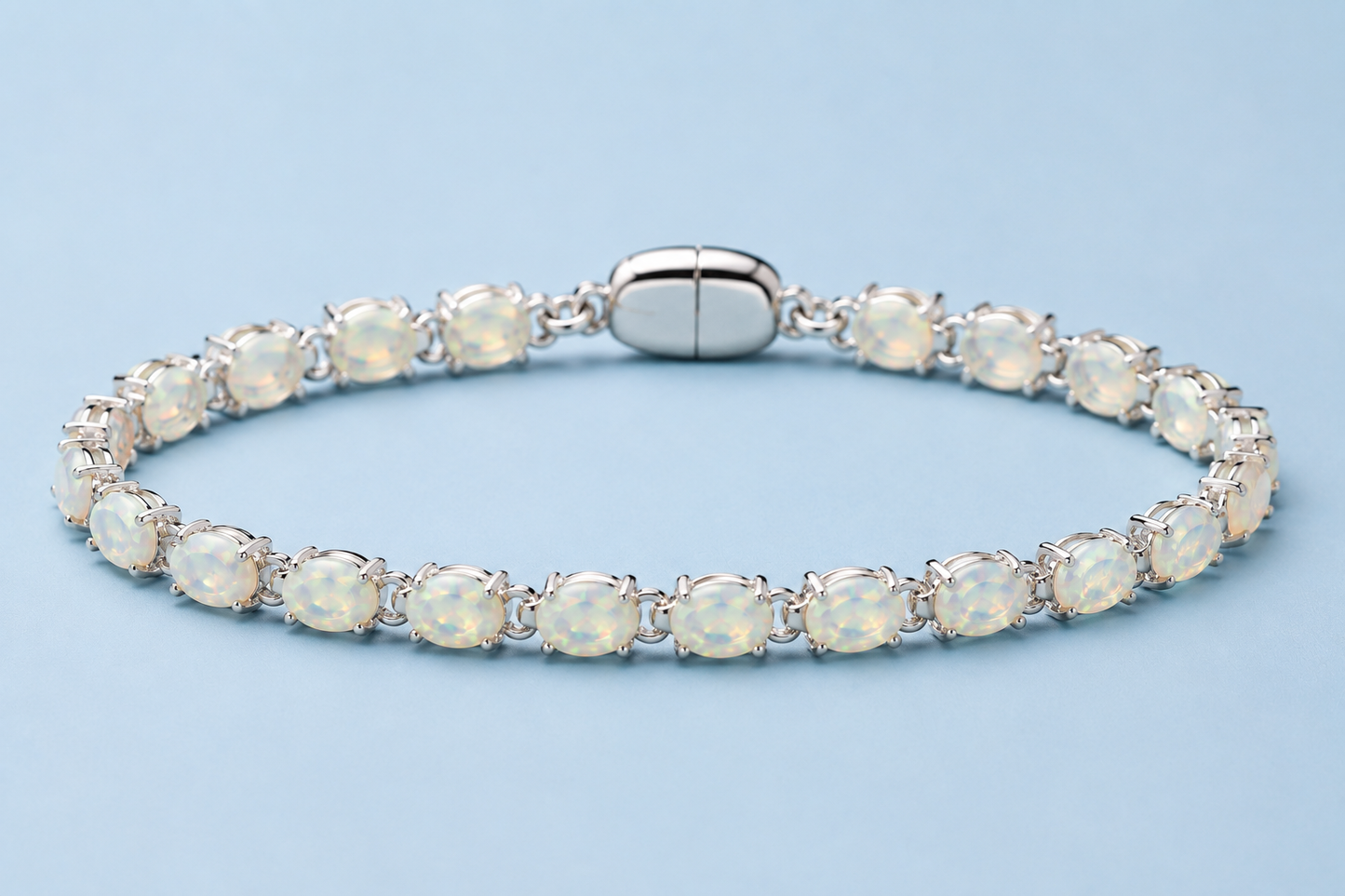 Ophelia white opal tennis bracelet in silver displayed on a light blue background