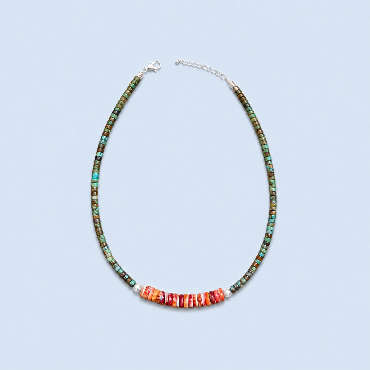 Sierra green turquoise and orange spiny oyster necklace with sterling silver accents on a light blue background