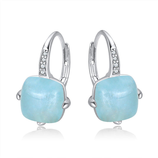 Platinum-tone sterling silver aquamarine hoop earrings with soft blue geometric stones.