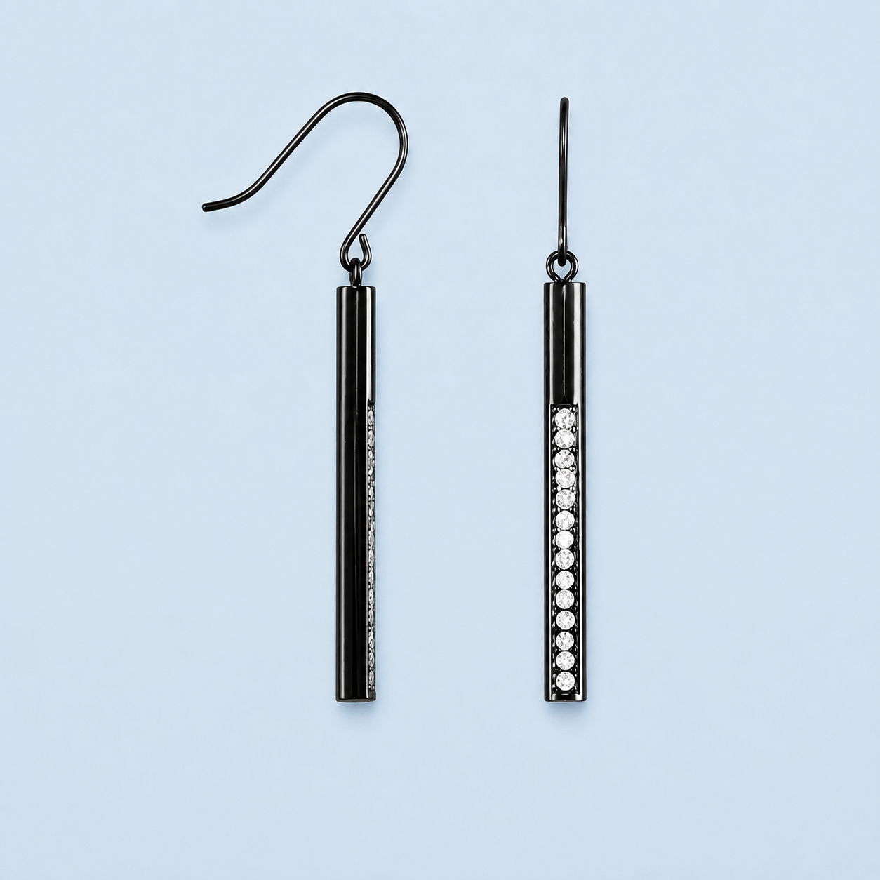     Sloane black bar drop earrings with crystal detail on pale blue background
    4