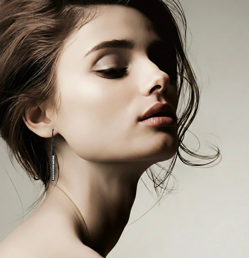     Close-up model wearing Sloane black bar drop earring