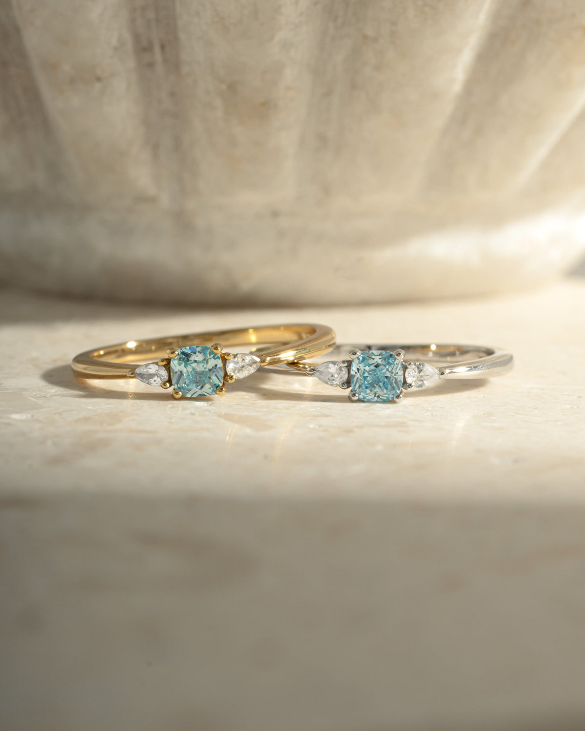 Kennedy Aquamarine Blue Cushion Ring shown in gold and silver finishes