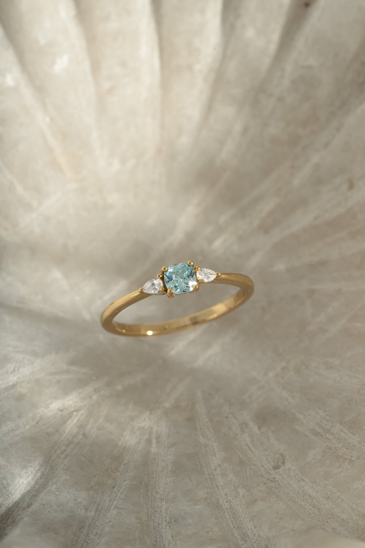 Side view of gold Kennedy Cushion Ring showing the setting and slim band