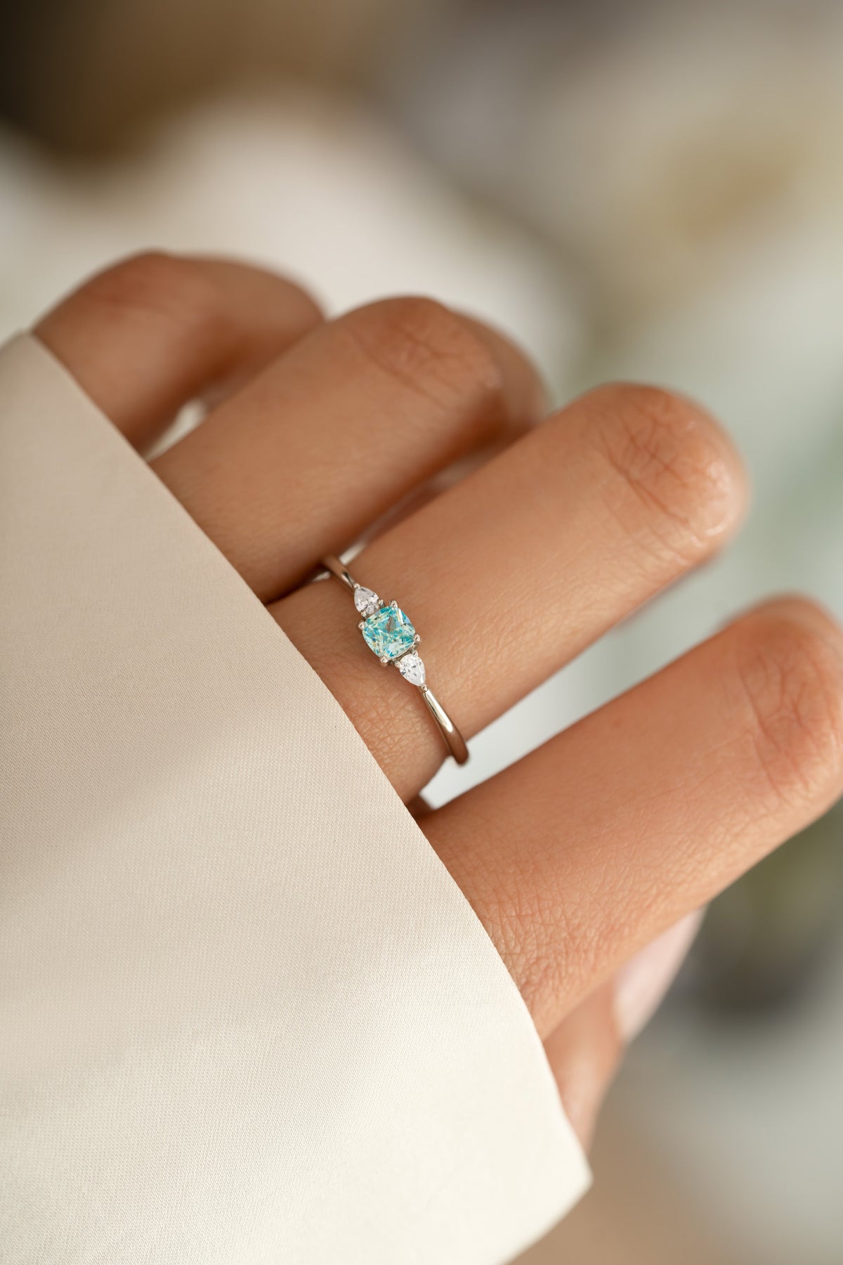 Silver Kennedy Aquamarine Blue Cushion Ring with blue cubic zirconia worn on hand