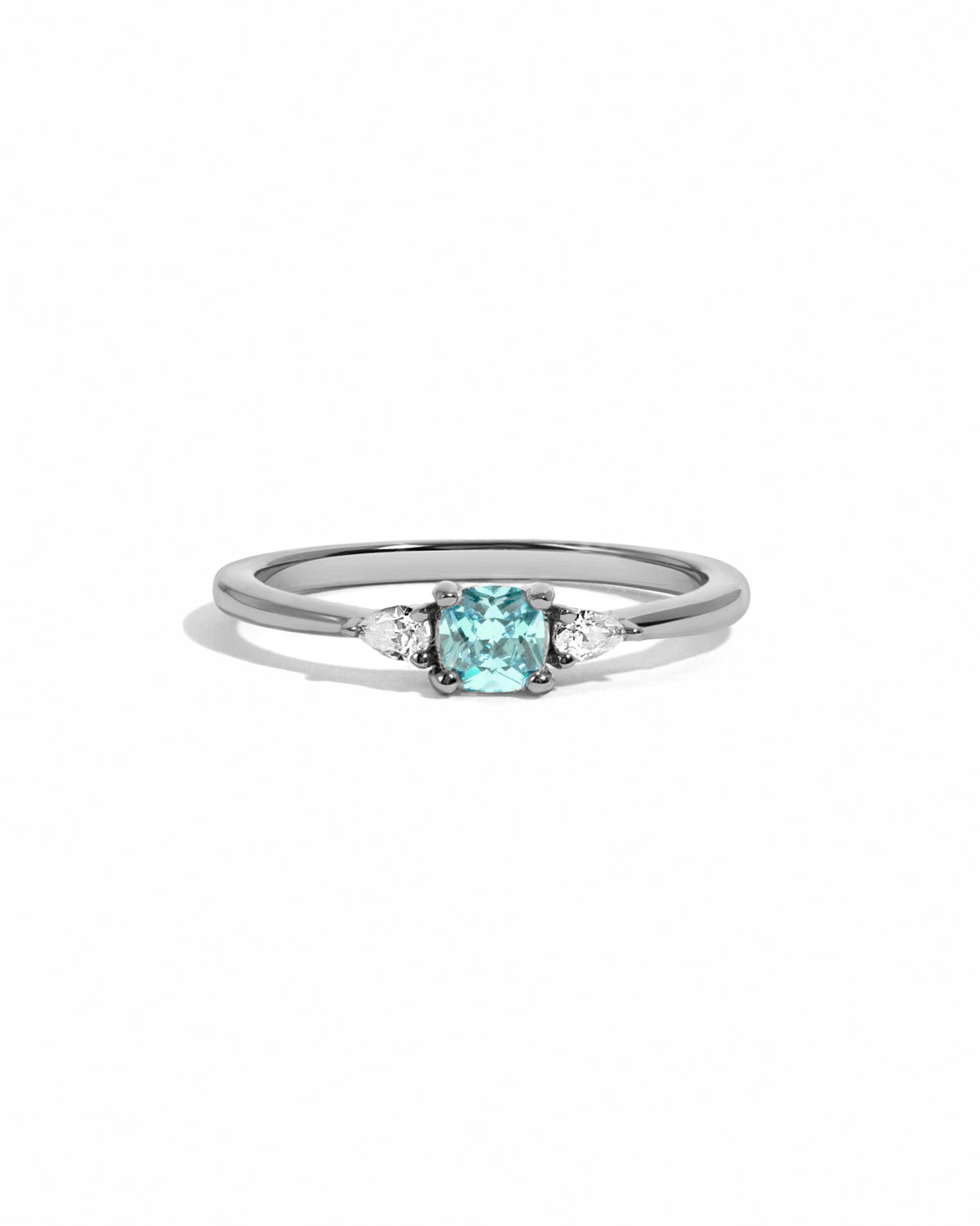 Close-up of silver Kennedy Cushion Ring with blue cushion-cut cubic zirconia and clear side stones