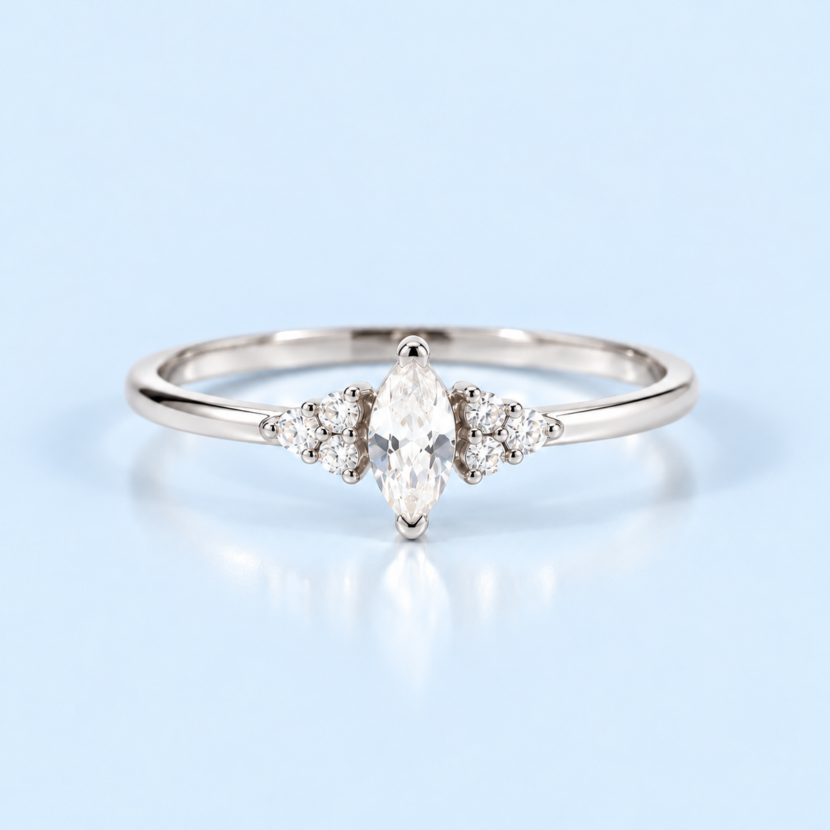 Silver Ari Marquise Ring with marquise cubic zirconia center stone on Riann Ashlyn blue background