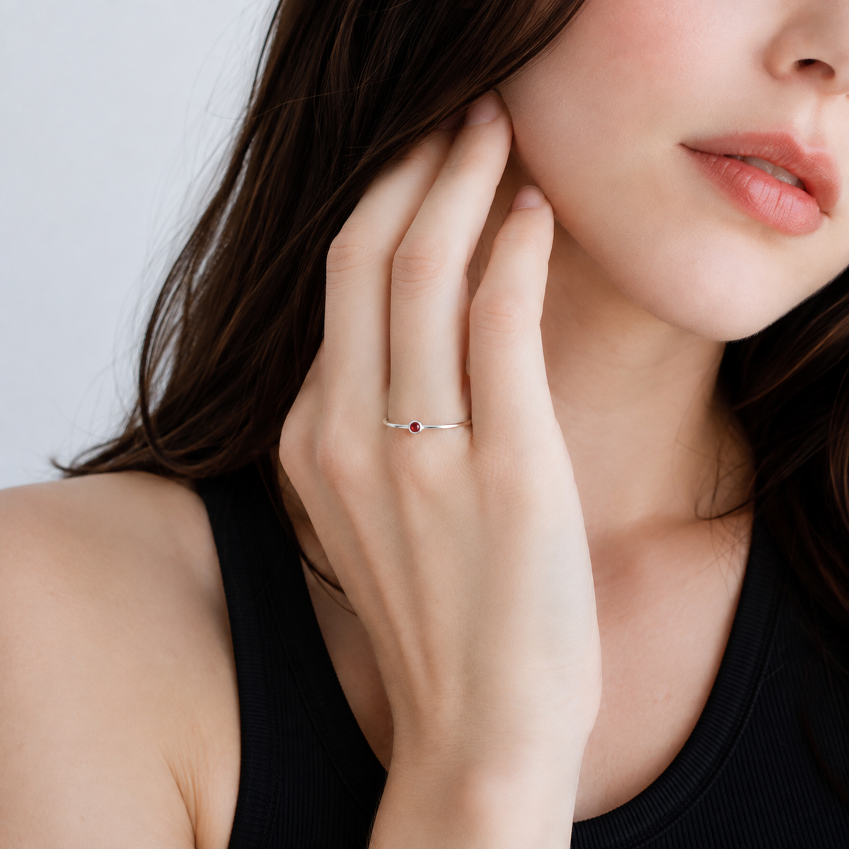    Model wearing the Ashlyn Tiny Garnet Birthstone Ring in sterling silver