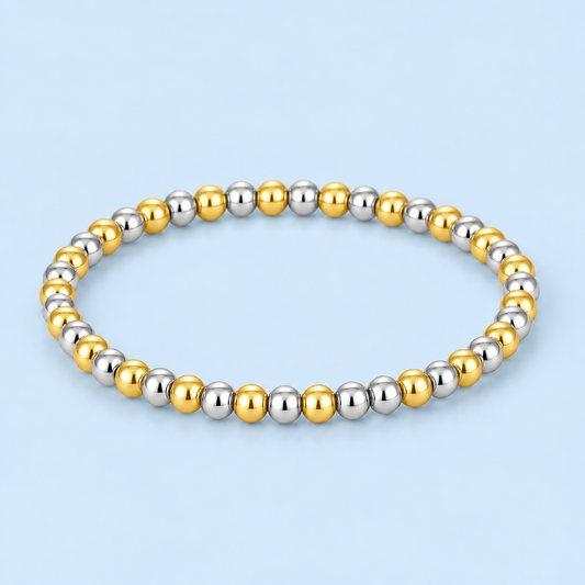 Aza two-tone stretch bead bracelet featuring polished gold and silver-tone round beads on a pale blue background.