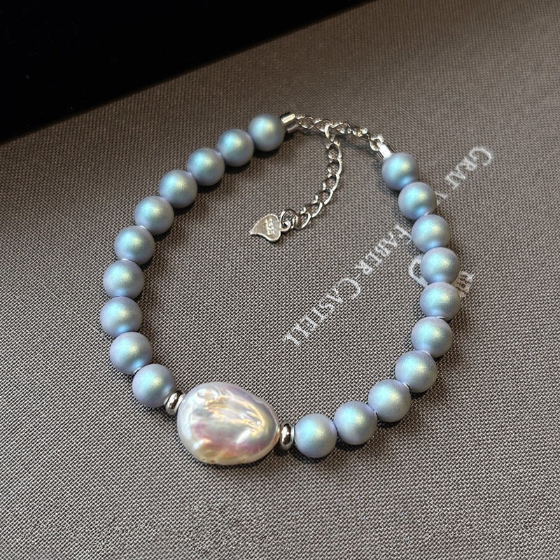 Blu Pearl Bracelet with light blue pearl beads and a single irregular white freshwater pearl centerpiece.