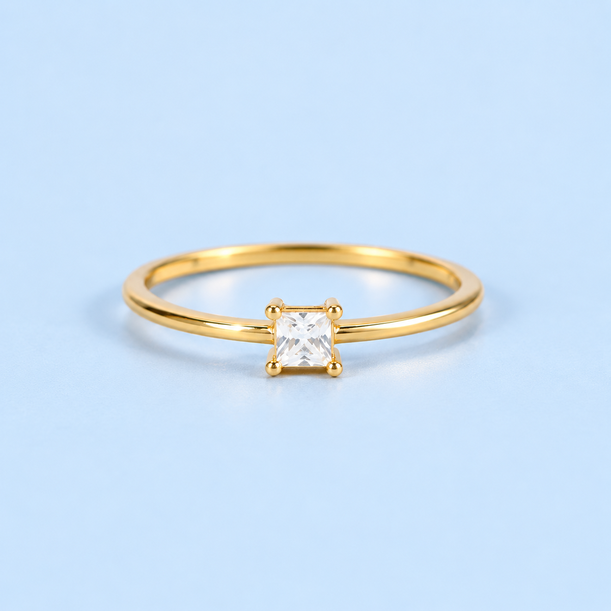     Campbell gold princess-cut cubic zirconia ring on a light blue background