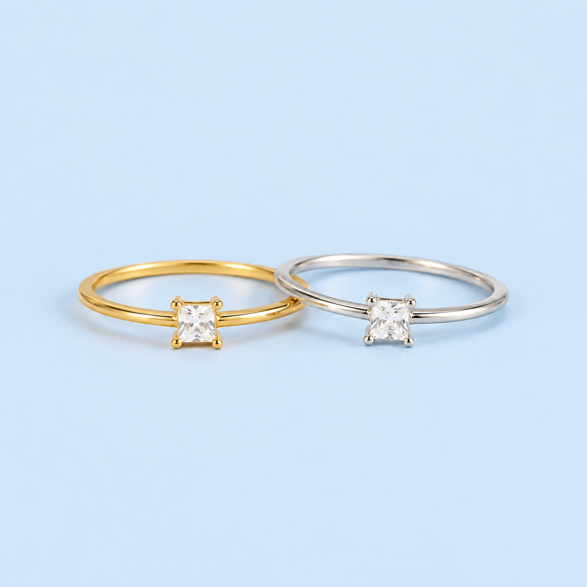     Campbell princess-cut cubic zirconia ring in gold and silver finishes on a light blue background