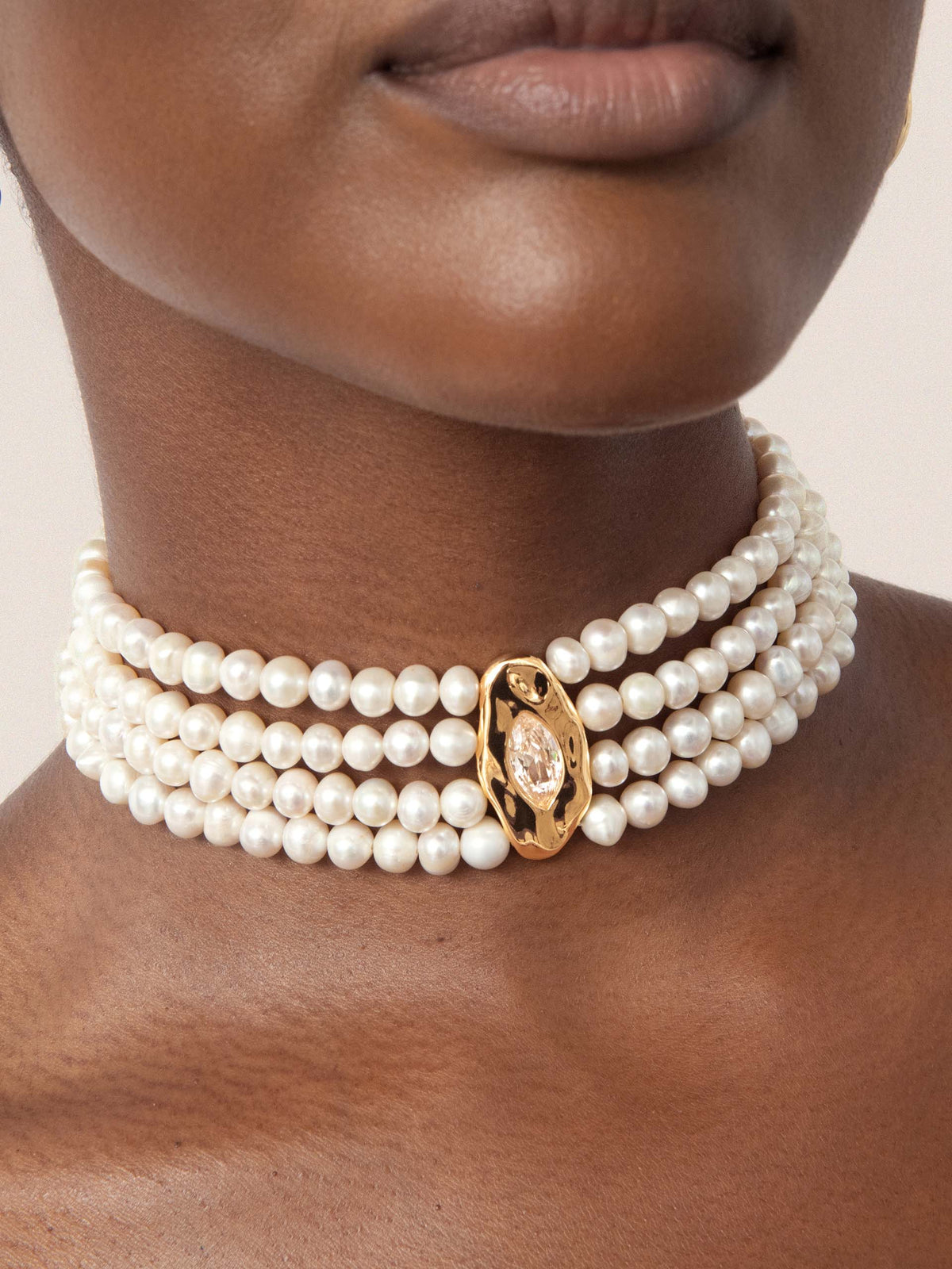     Model wearing Chandler multi-strand freshwater pearl choker with gold-plated centerpiece