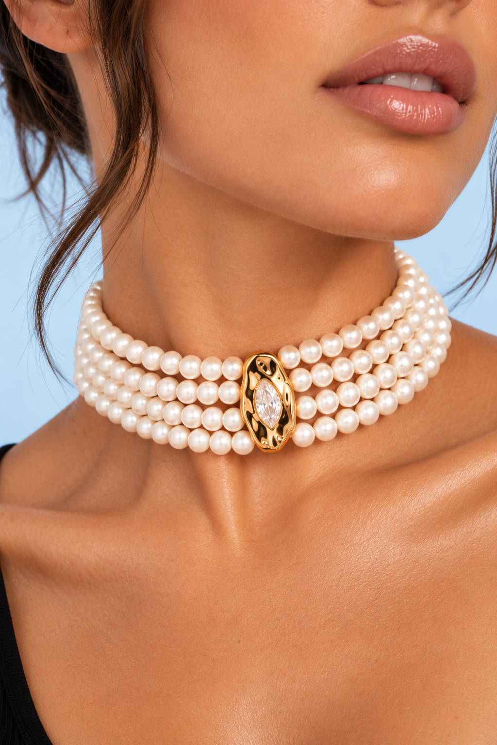 Close-up of model wearing the Chandler Freshwater Pearl Luxe Choker with gold-tone clasp against a pale blue background