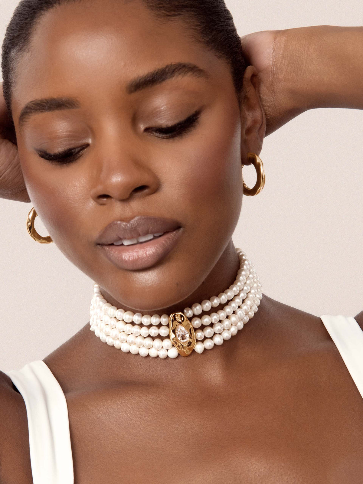     Model wearing Chandler freshwater pearl choker with gold-plated centerpiece