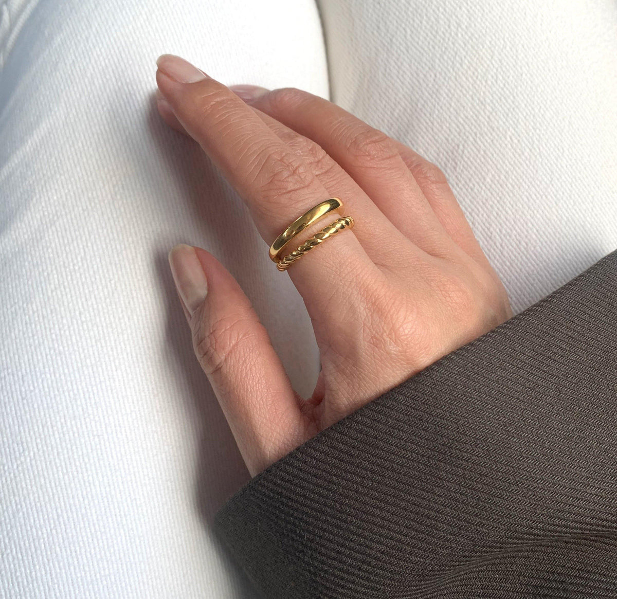 Cleo gold double band ring worn on hand showing smooth and twisted rope bands