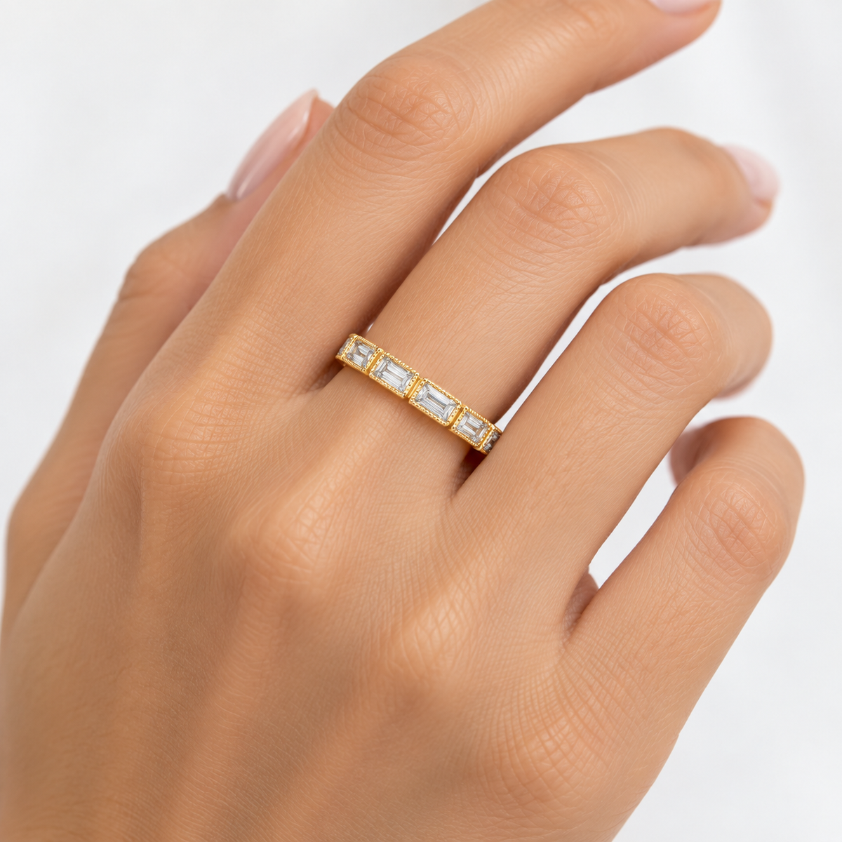 Fallon gold-plated baguette ring worn on a model’s hand