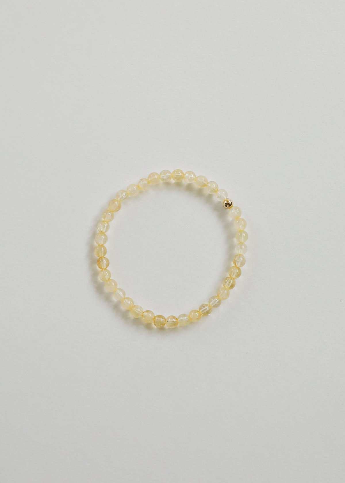 Close view of Fia's small citrine gemstone beads and one 14K gold-filled accent bead, from The Riann Ashlyn Collection.