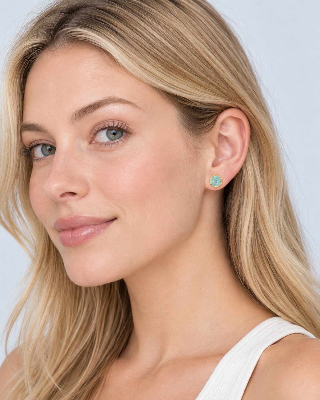     model wearing Gemma natural turquoise stud earrings in gold