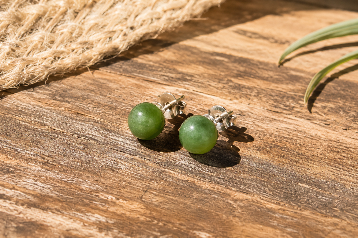     of Giada Canadian jade stud earrings on a wooden background