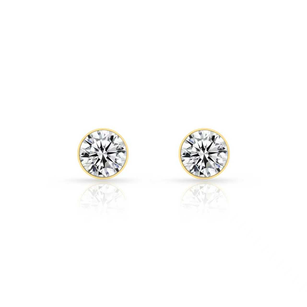 Front view of gold bezel-set stud earrings with round clear stones on a white background