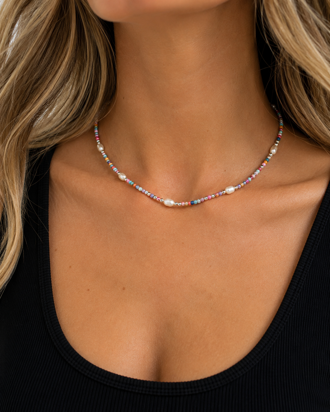 Model wearing the Indy Necklace with multicolor beads, sterling silver beads and genuine freshwater pearls with a black tank top.