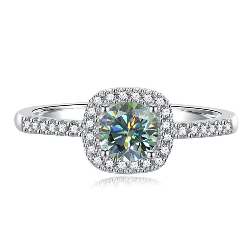 Madison sterling silver halo ring with a Rainbow Green moissanite center stone and pavé-set band on a white background.