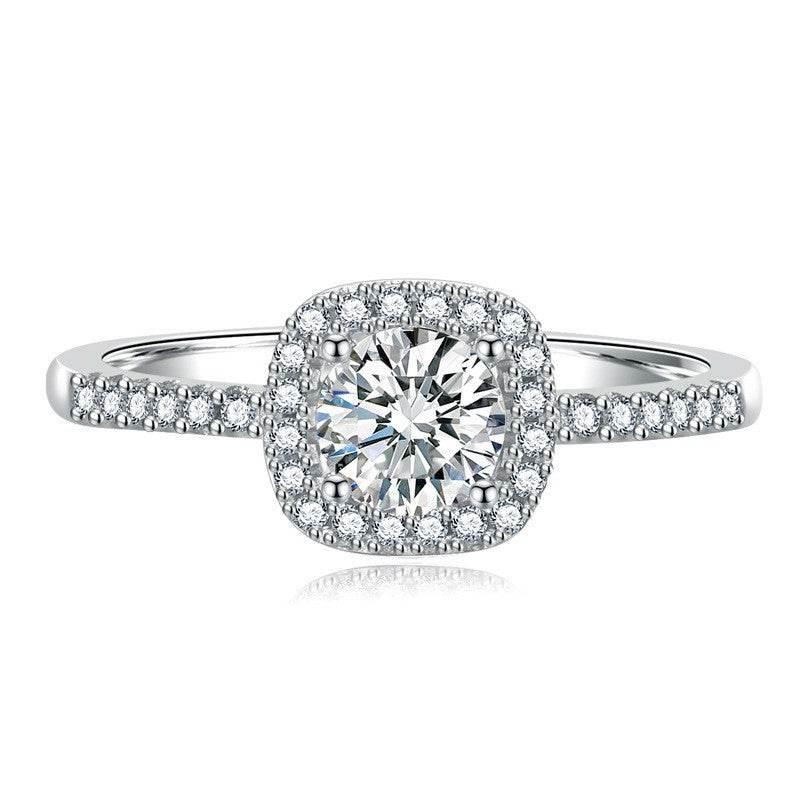 Madison sterling silver halo ring with a White moissanite center stone and pavé-set band on a white background.