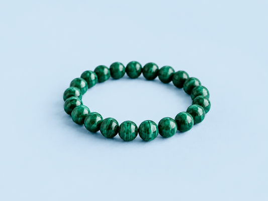 Mazzy natural malachite beaded bracelet on a light blue background