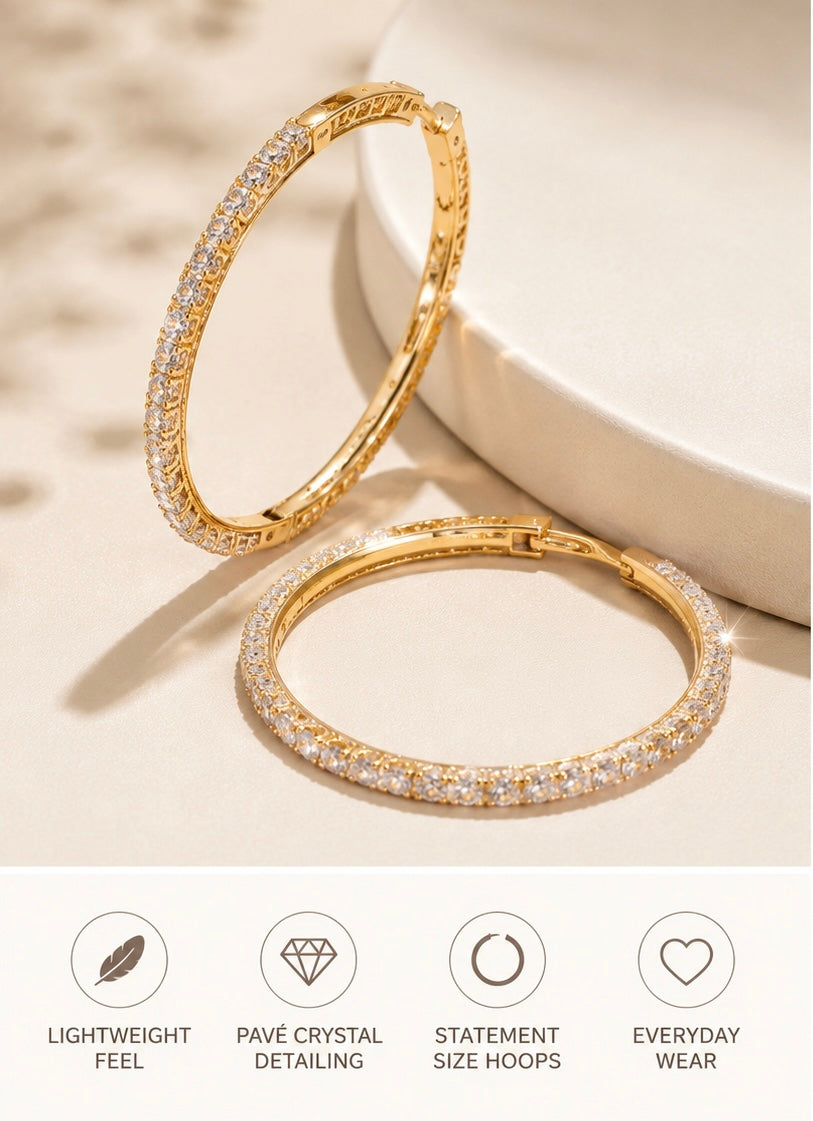 Monroe gold pavé hoop earrings with clear stones shown with lightweight, pavé crystal, statement-size, and everyday-wear feature icons.