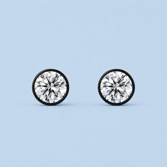 Noir Solitaire Stud Earrings with round diamond-alternative stones in black settings on pale blue background