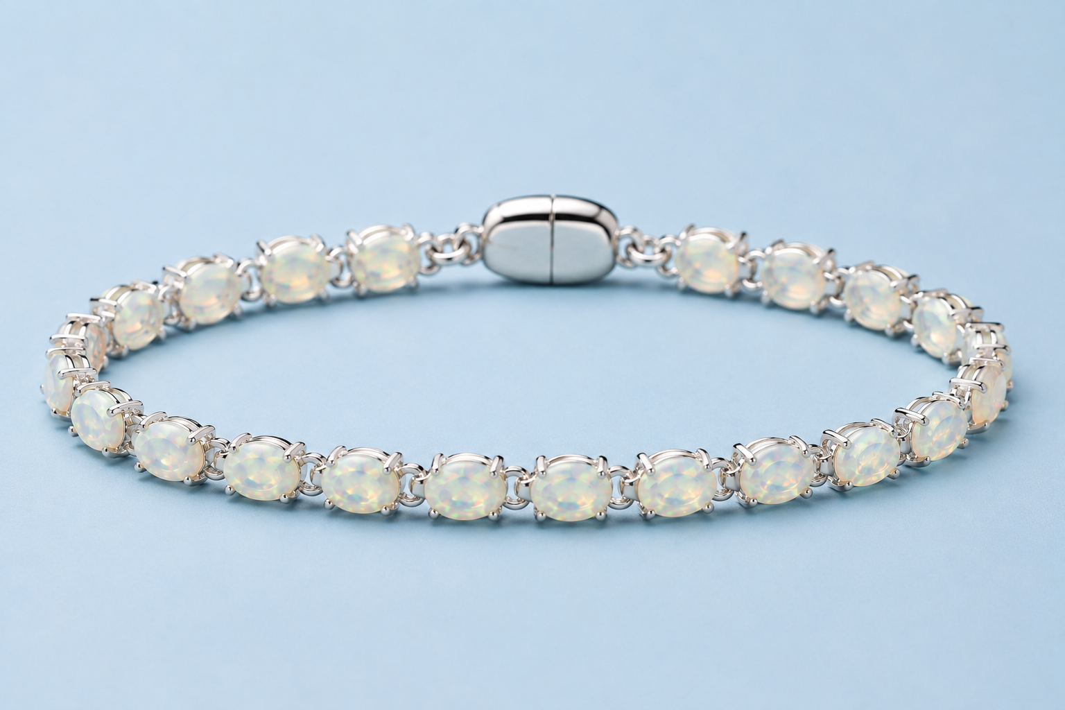 Ophelia white opal tennis bracelet in silver displayed on a light blue background