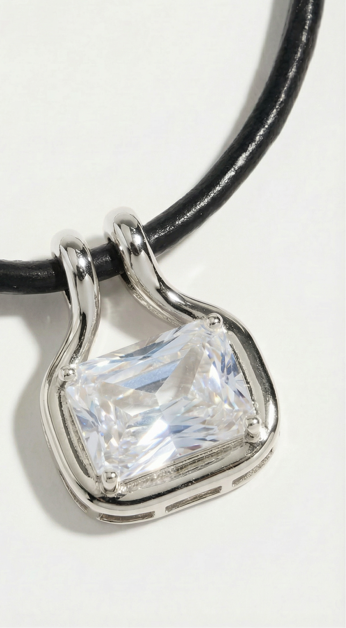 Close-up of Palmer cubic zirconia pendant with rhodium-plated brass on black leather cord