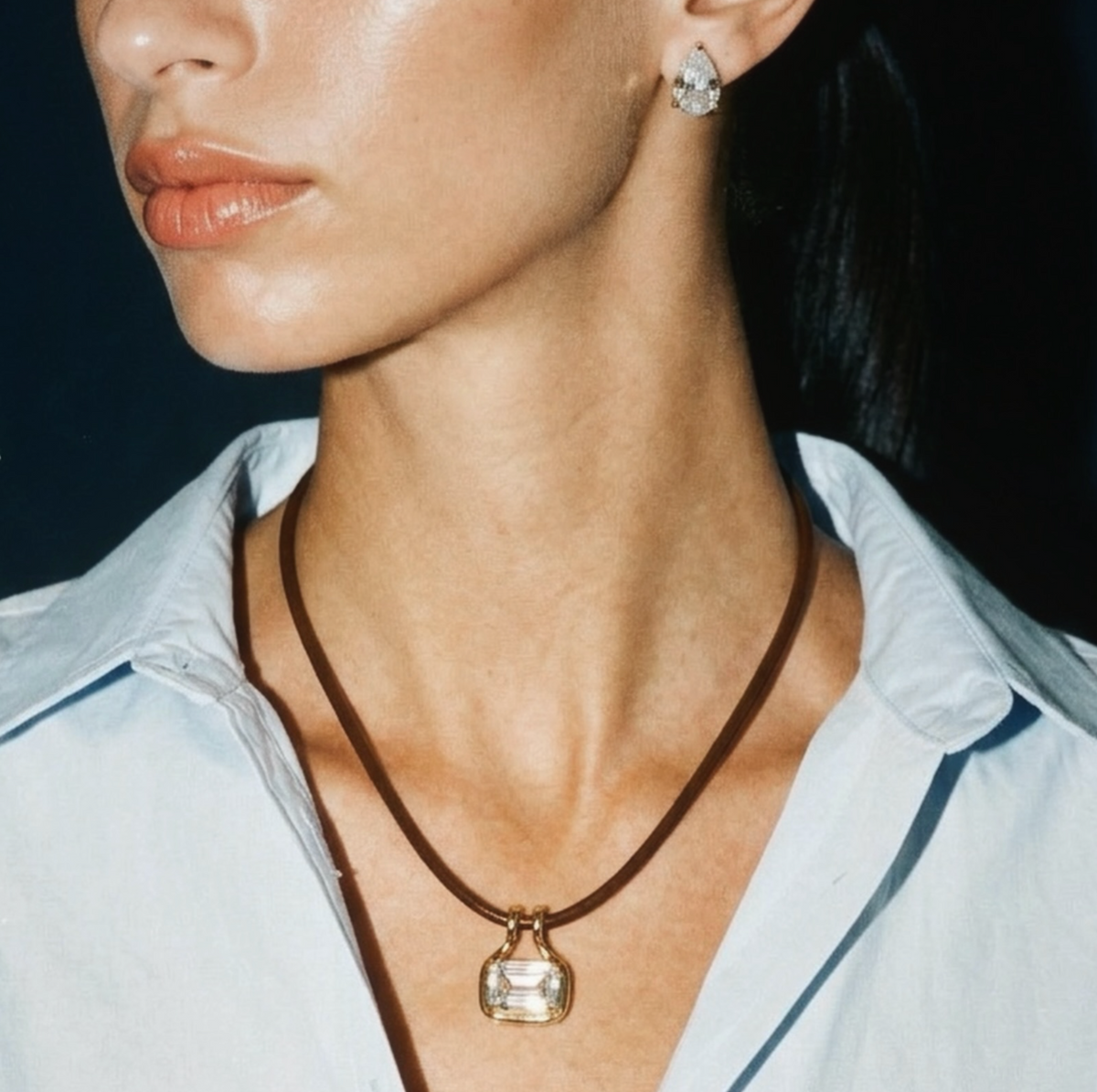 Model wearing Palmer cubic zirconia pendant necklace on a brown leather cord