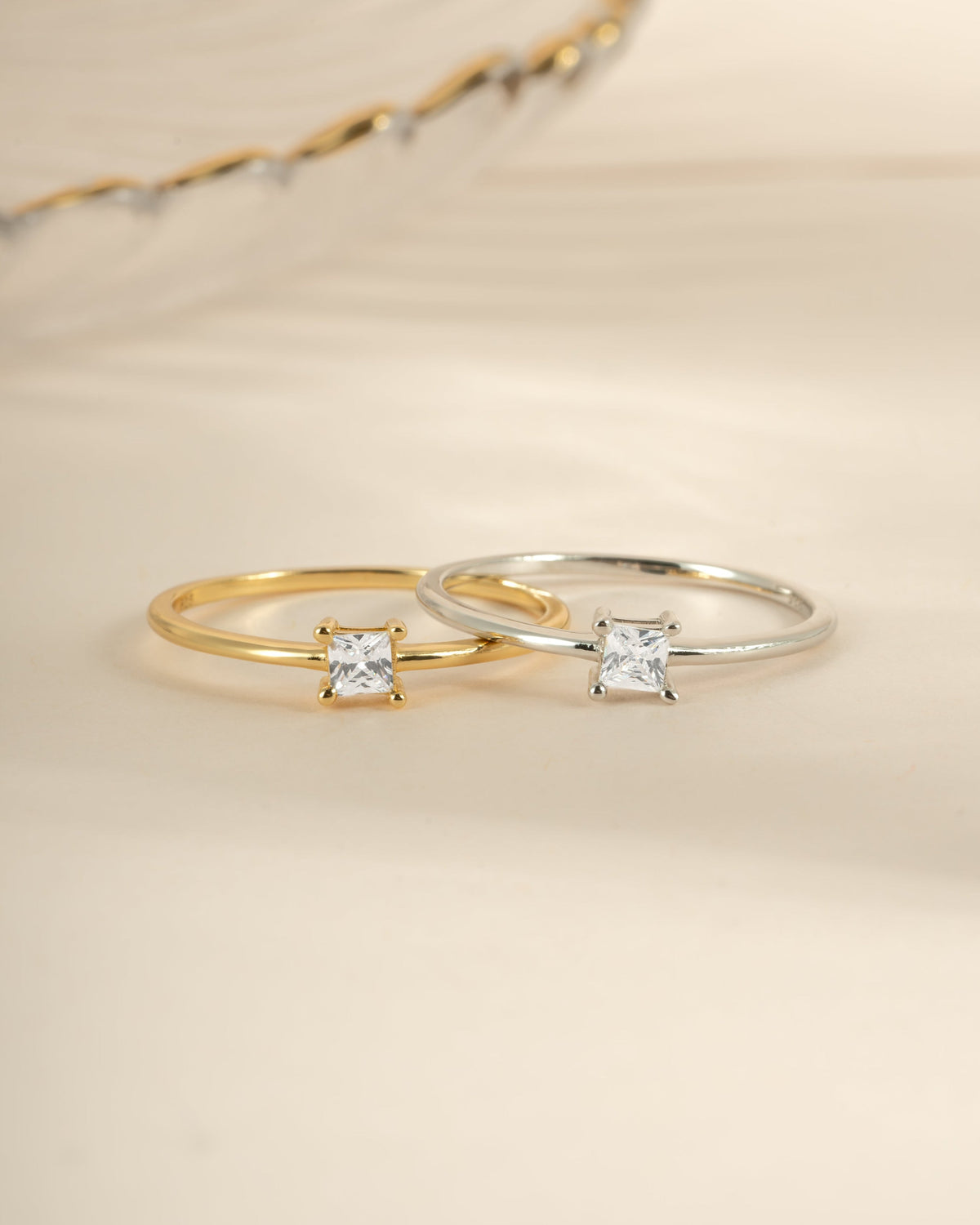    Campbell princess-cut cubic zirconia rings shown together in gold and silver finishes