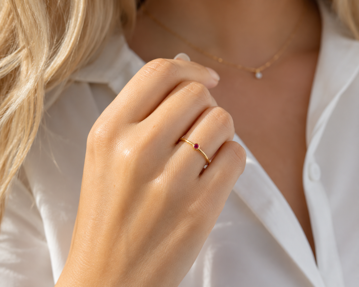     Close-up of Riann Tiny Ruby Birthstone Ring worn on hand