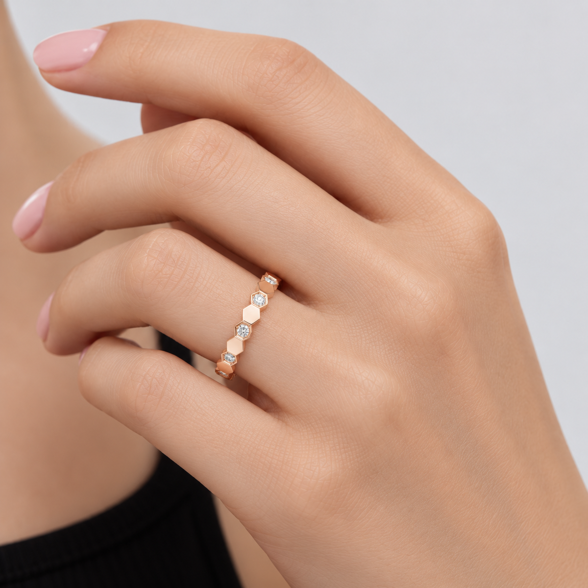 Romy rose gold hexagon pavé ring styled on hand with black sleeveless top