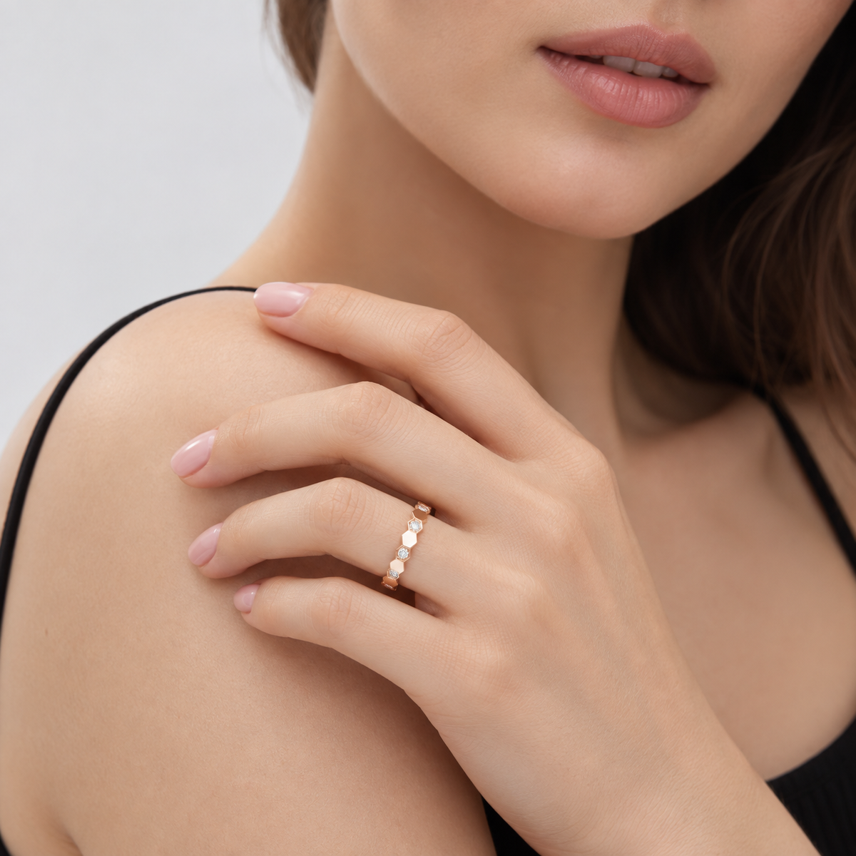 Woman wearing Romy rose gold hexagon pavé ring with black top
