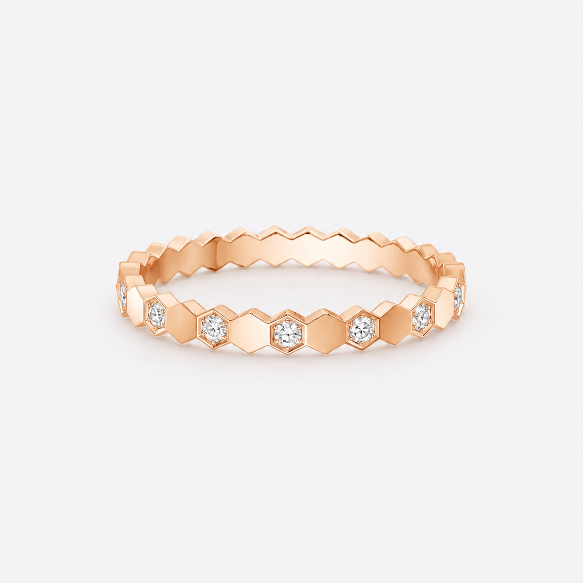 Romy rose gold hexagon pavé ring with alternating clear stones on pale gray background