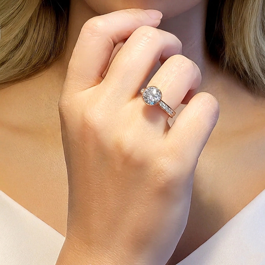 Close-up of Sia rose gold 2 ct solitaire pavé ring worn on hand