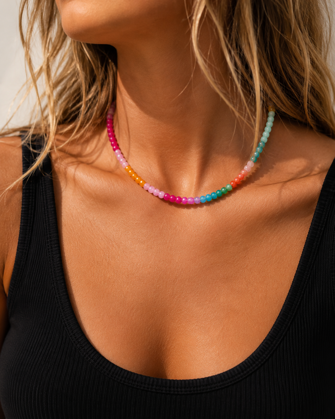 Model wearing the Soleil colorful beaded necklace with a black tank top