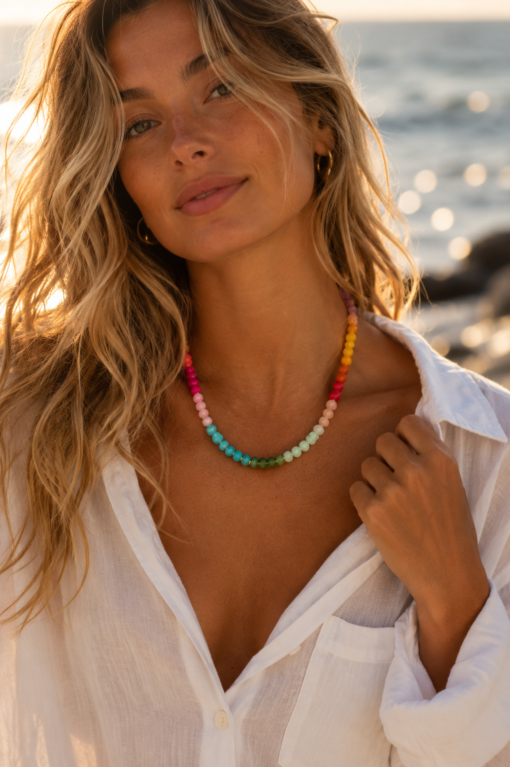 Model wearing the Soleil colorful beaded necklace with a white shirt