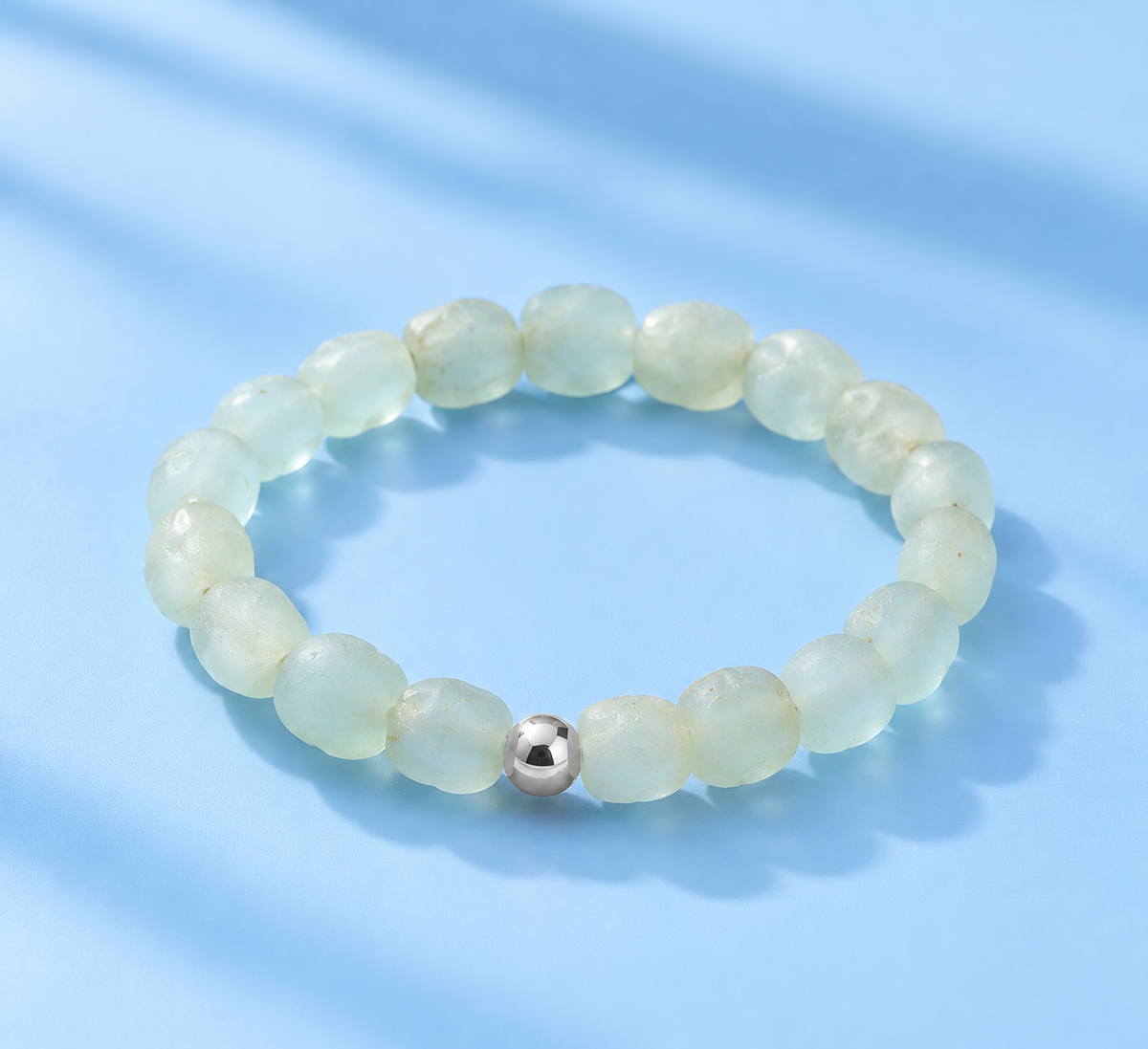 Sora blue-green sea glass stretch bracelet with frosted natural glass beads and a single sterling silver accent — The Riann Ashlyn Collection.