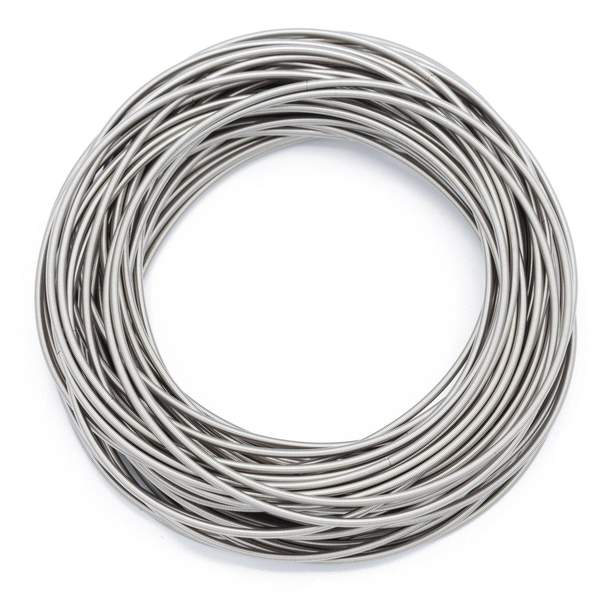 Zadie stainless steel spring bracelets arranged in an overlapping silver stack on white