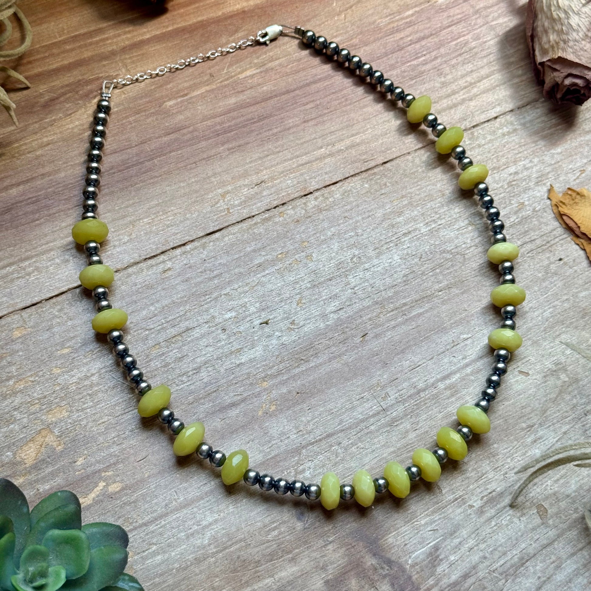 Angled view of Zia lemon jade necklace with sterling silver pearls and extender chain