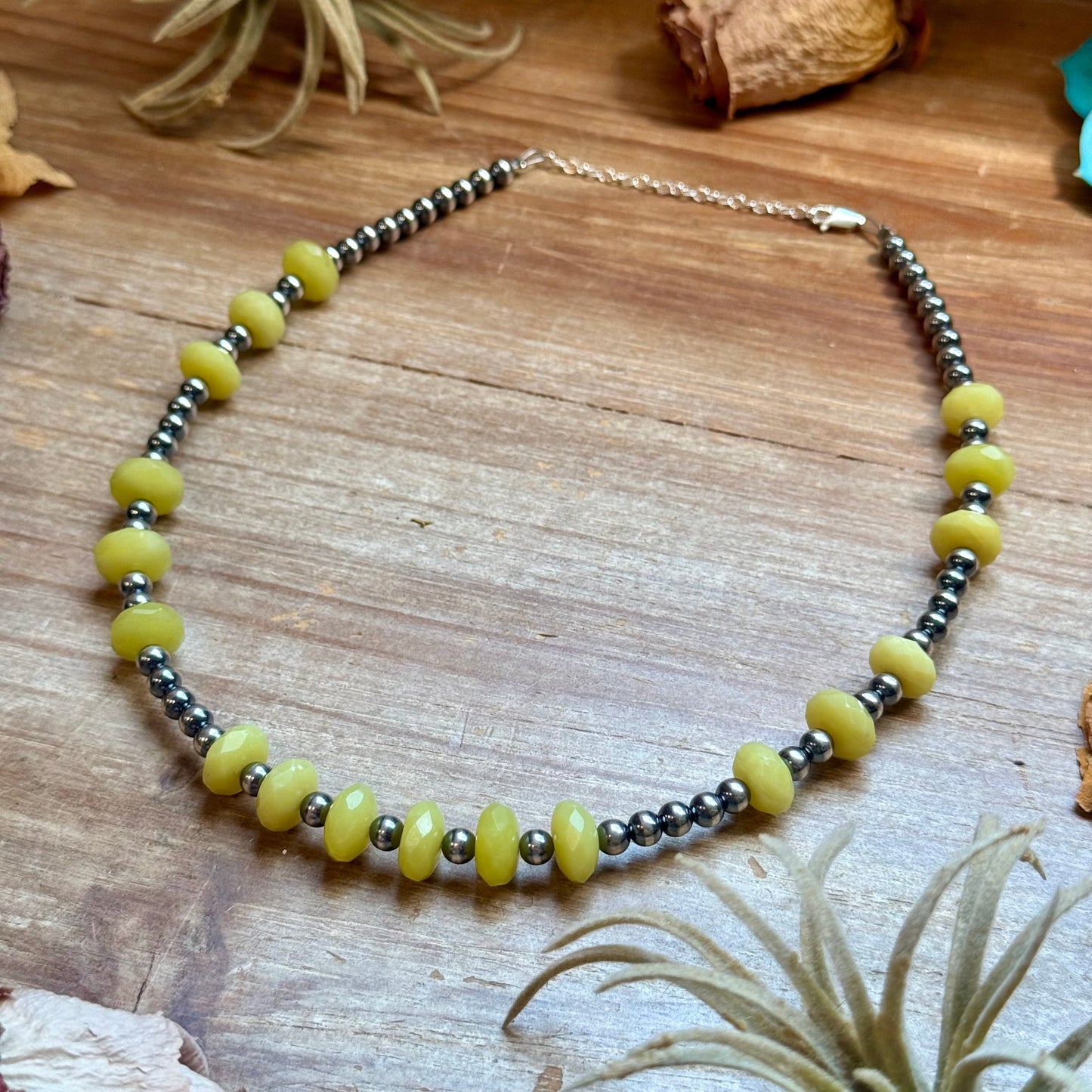 Close-up of faceted lemon jade beads and sterling silver pearls on the Zia necklace